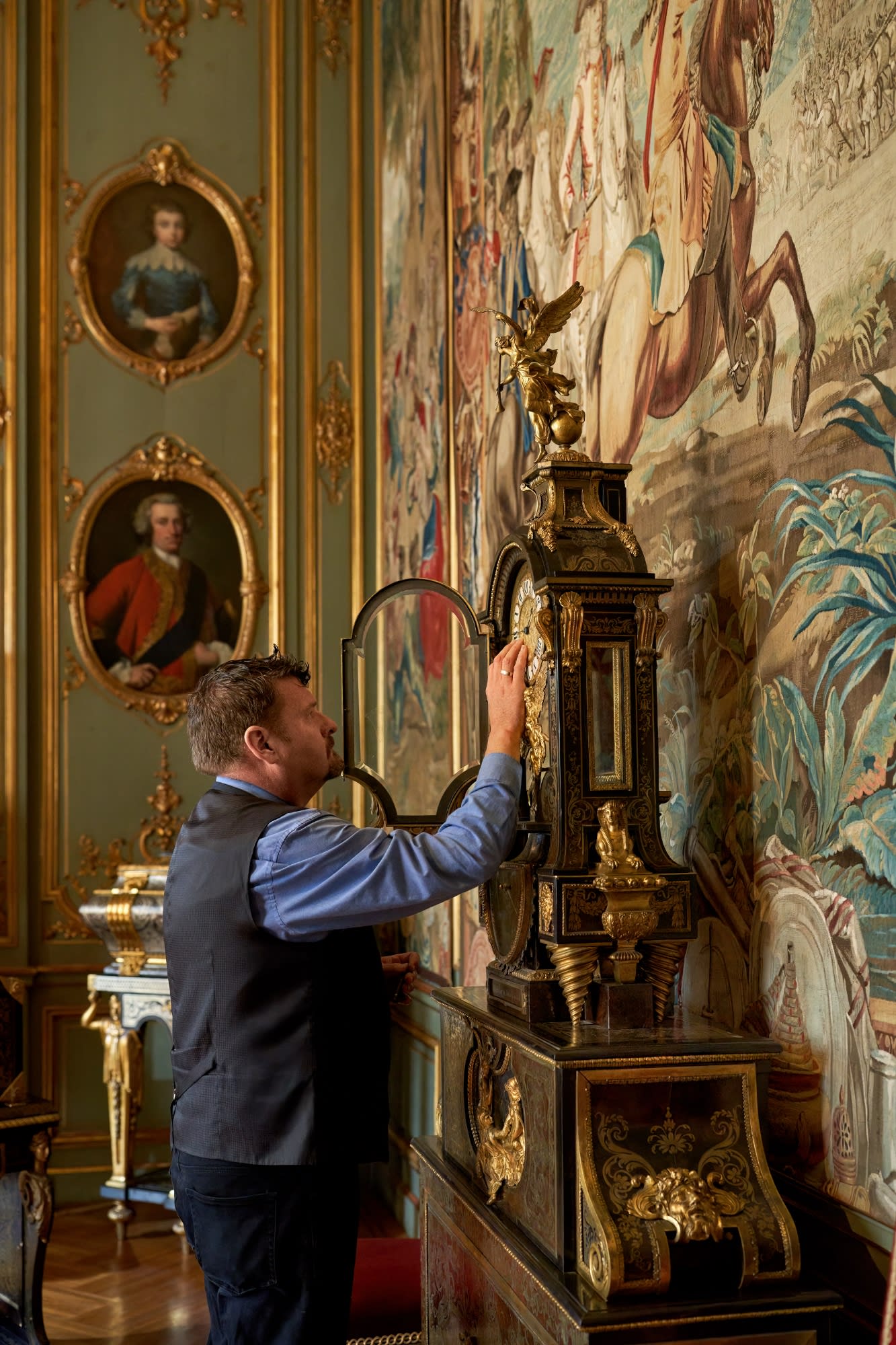 Blenheim timekeeper Julian Newman turns back the hands on a Boulle table clock with barometer circa 1710 in the Palace s 3rd state room