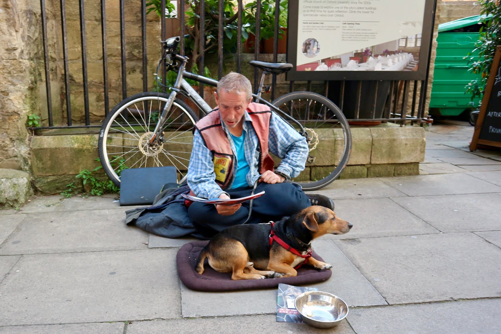 Oxford England 25 August 2017 A homeless sitting at street with his dog