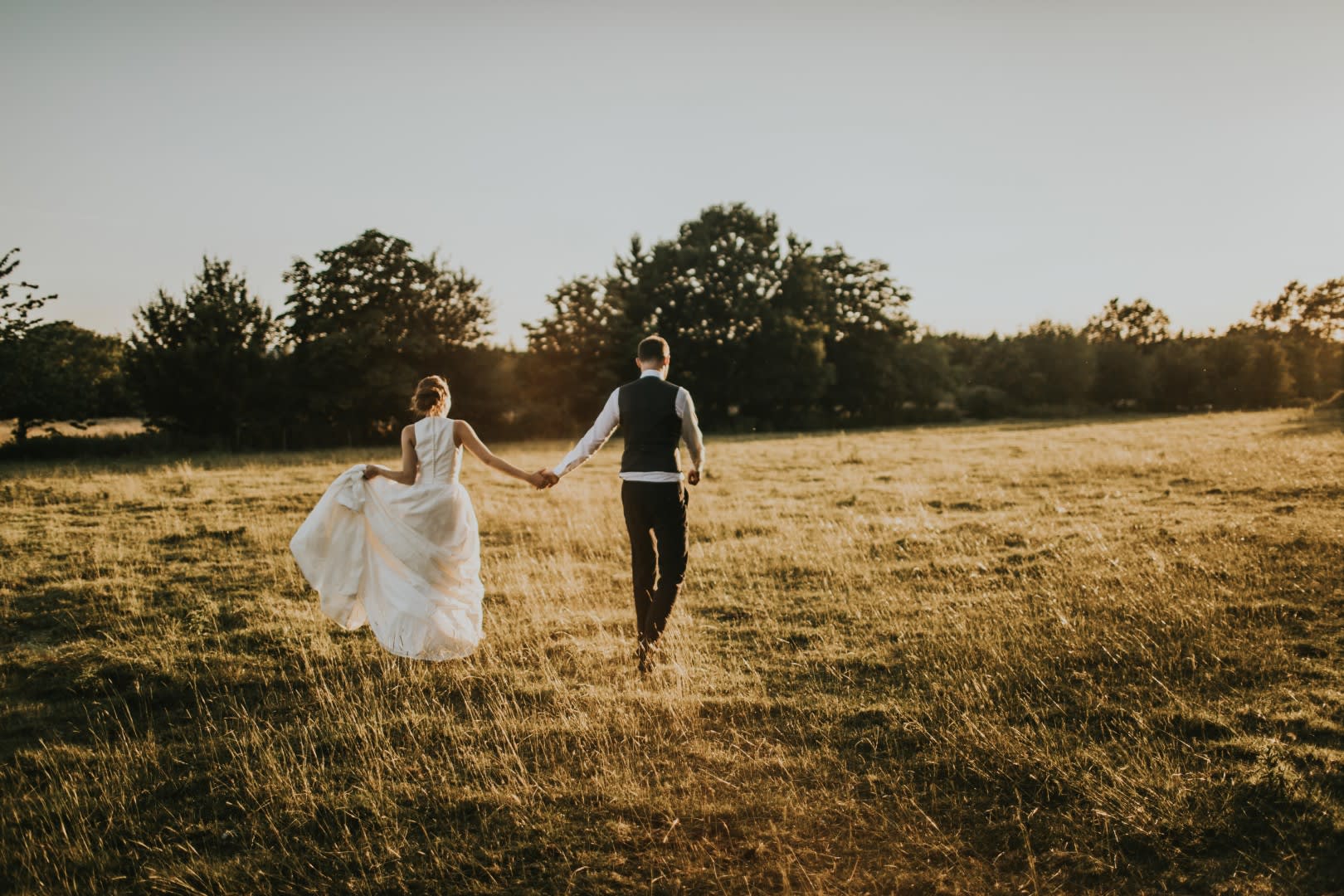 Tythe Barn Wedding Couple Walking in Field